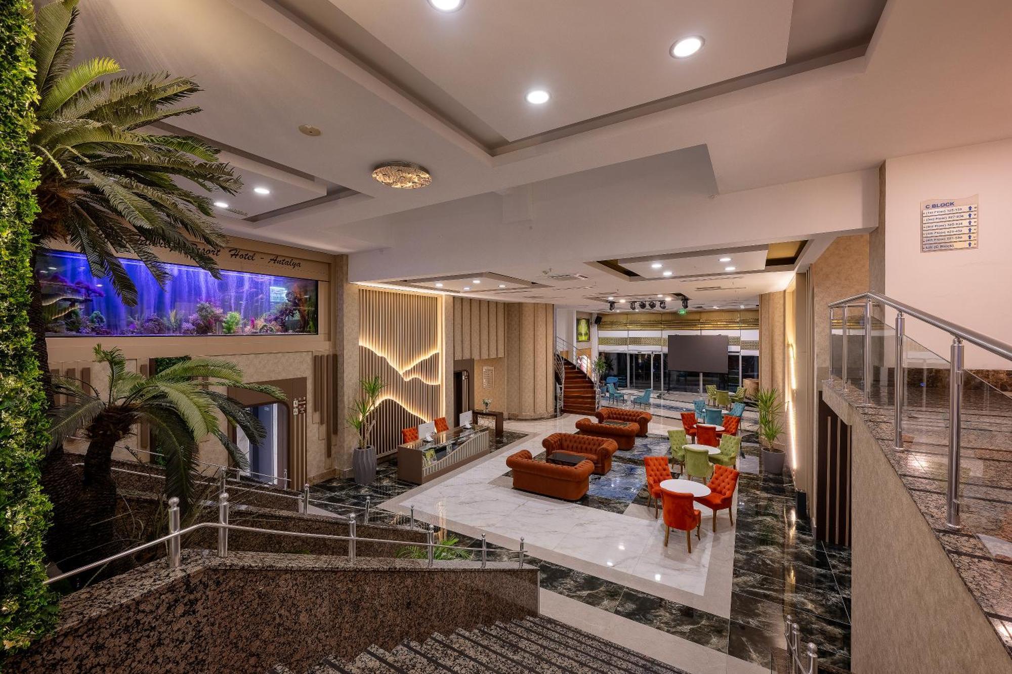 אנטליה Sealife Family Resort Hotel מראה חיצוני תמונה The photo shows a spacious and modern lobby area of a building, possibly a hotel. It features a combination of elegant decor and comfortable seating arrangements. There are large windows allowing natural light in, and the space includes a mix of indo